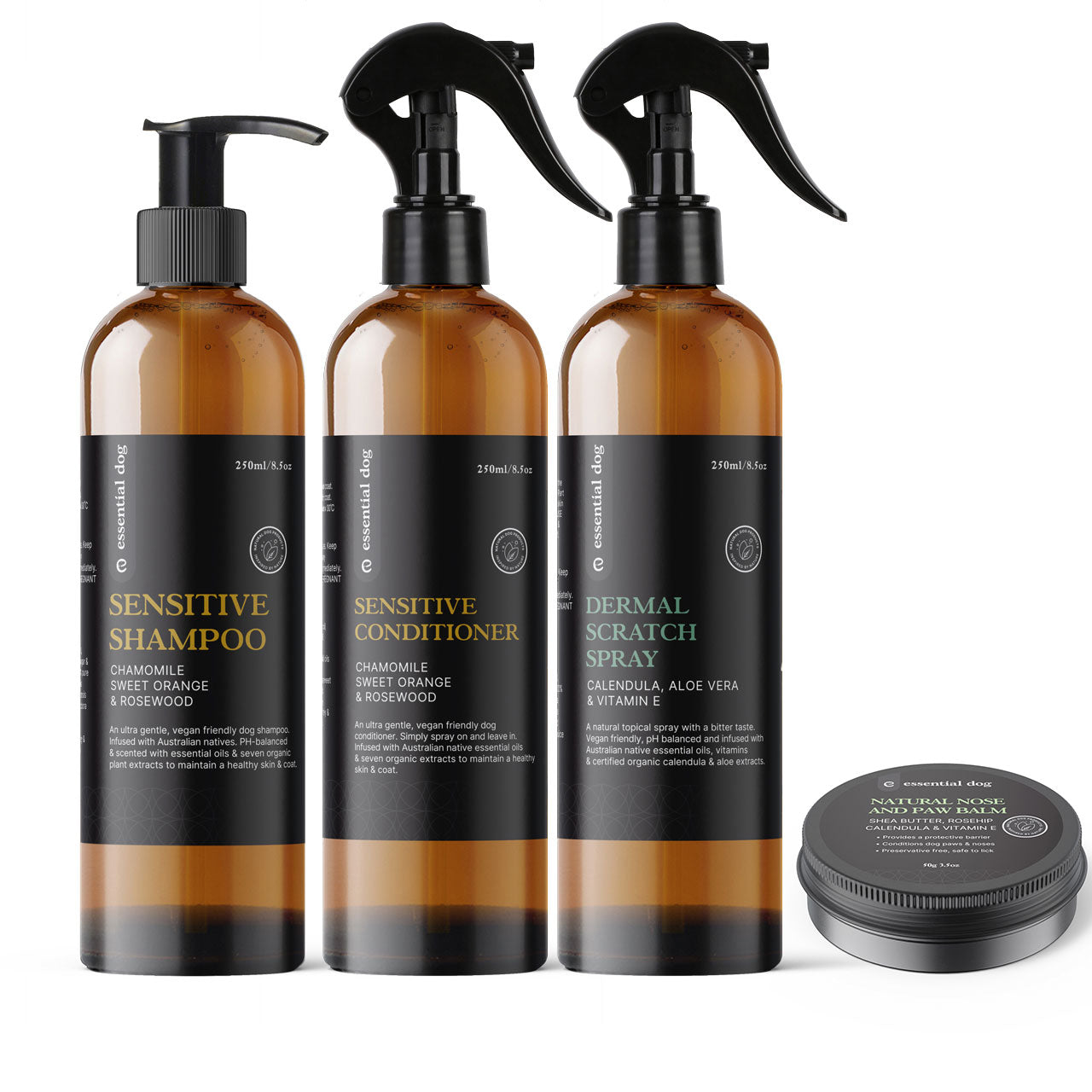 Set of three amber bottles labeled 'Sensitive Shampoo', 'Sensitive Conditioner', and 'Dermal Scratch Spray' with a small round container on a white background.